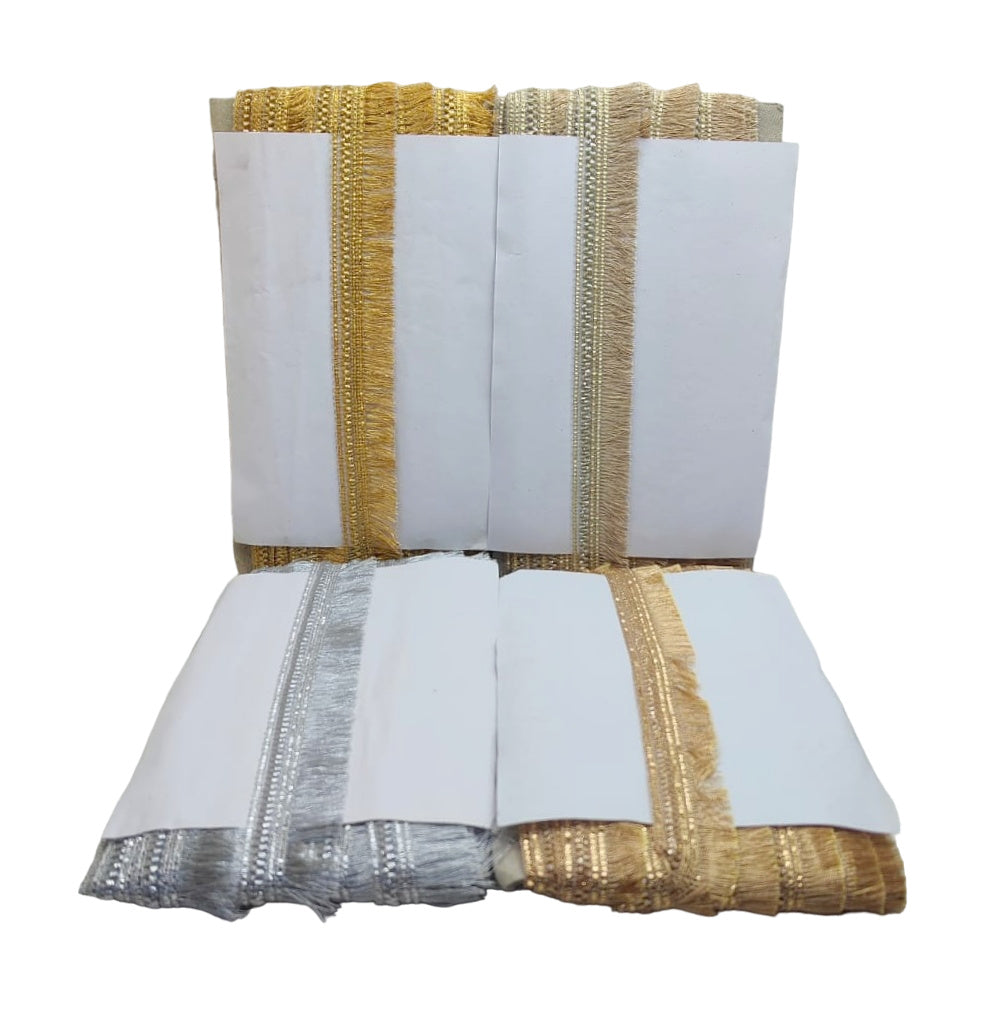 White fabric with gold and silver trim on a white background