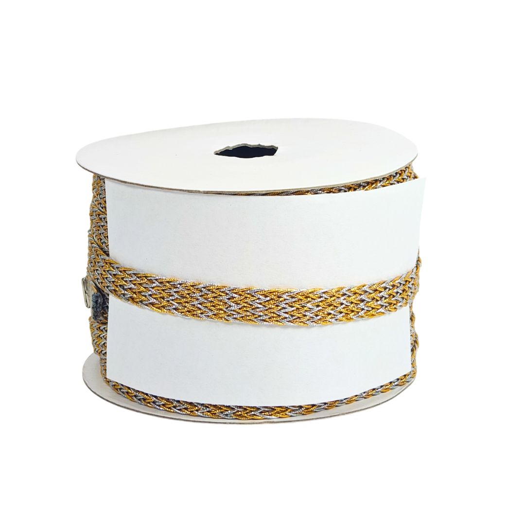 Spool of white ribbon with gold and silver pattern on a white background