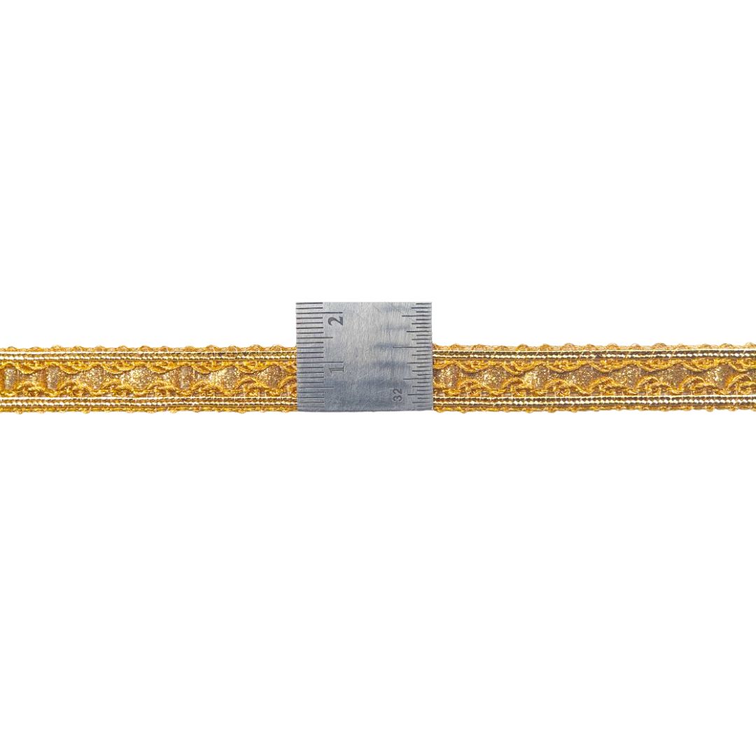 Gold decorative ribbon with a silver measuring tool on a white background