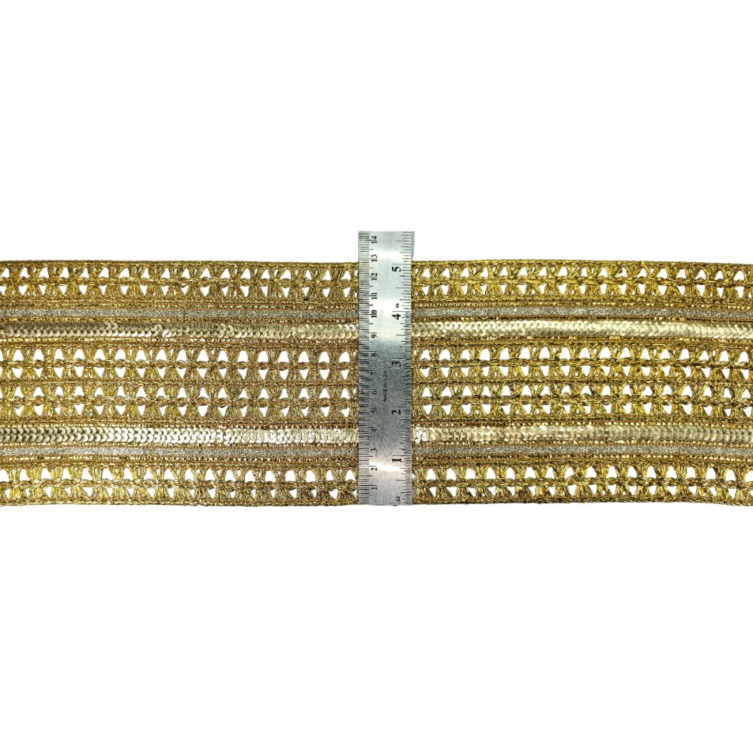 Gold decorative trim with a ruler for scale on a white background