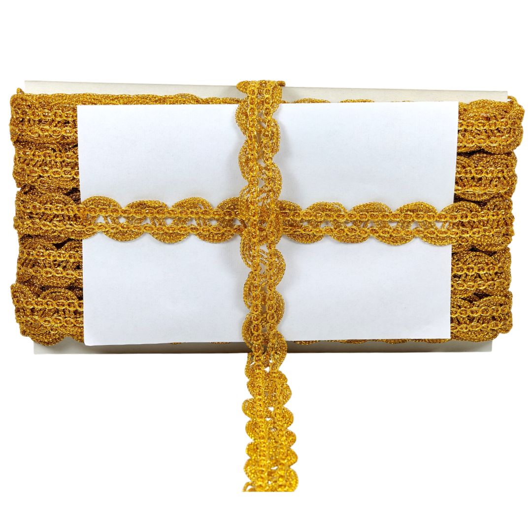 White clutch with gold crochet detailing on a white background