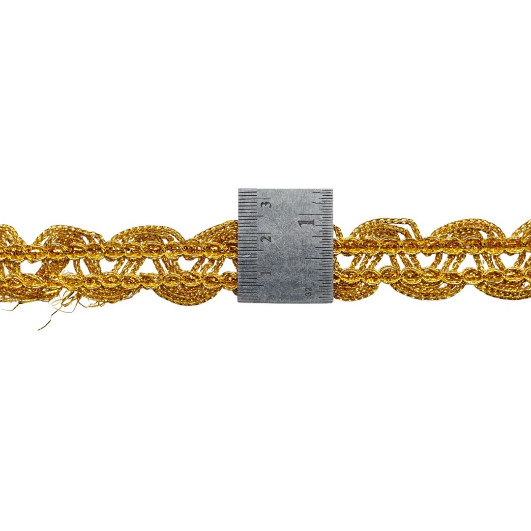 Gold braided cord with a ruler for scale on a white background