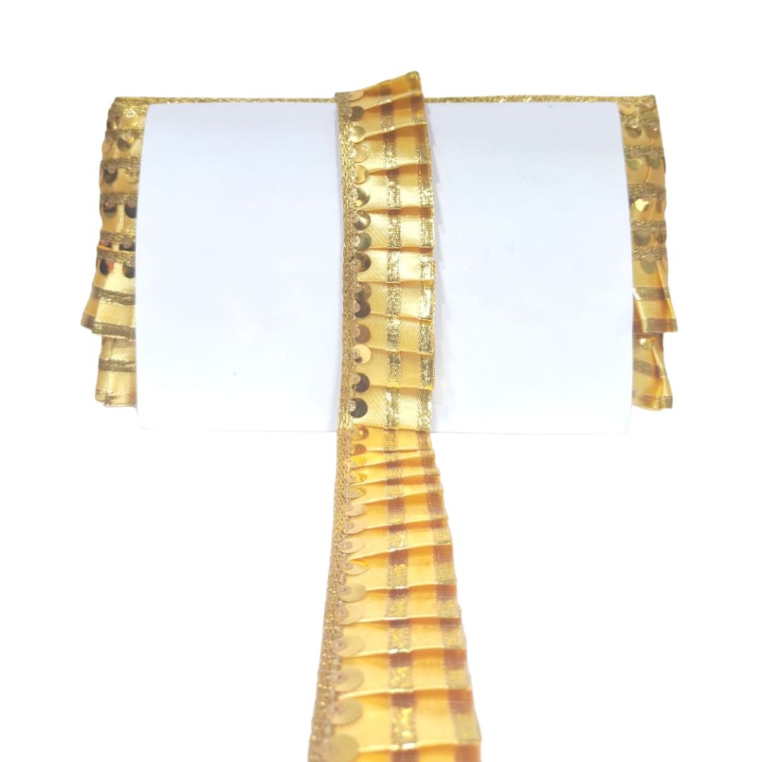 Gold and white dress with ruffled sleeves on a white background