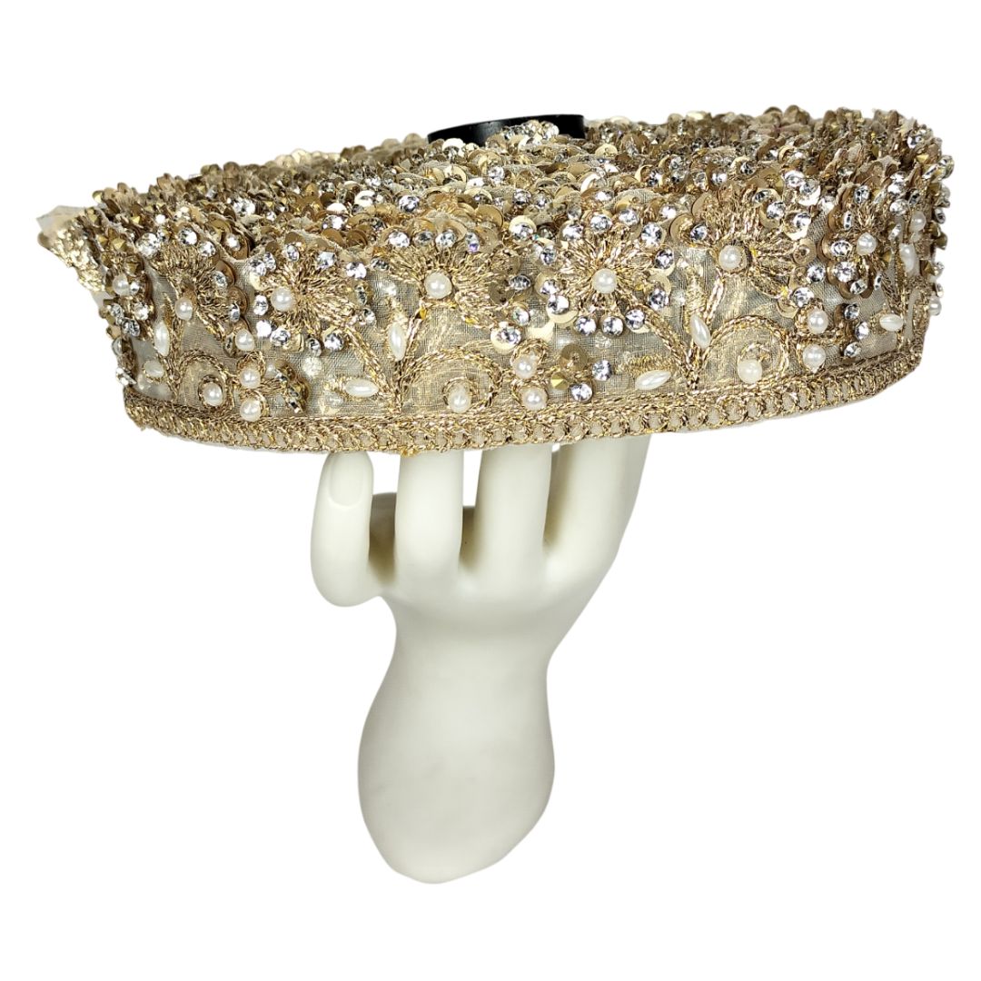 Decorative headband with gold and silver embellishments on a white mannequin head.