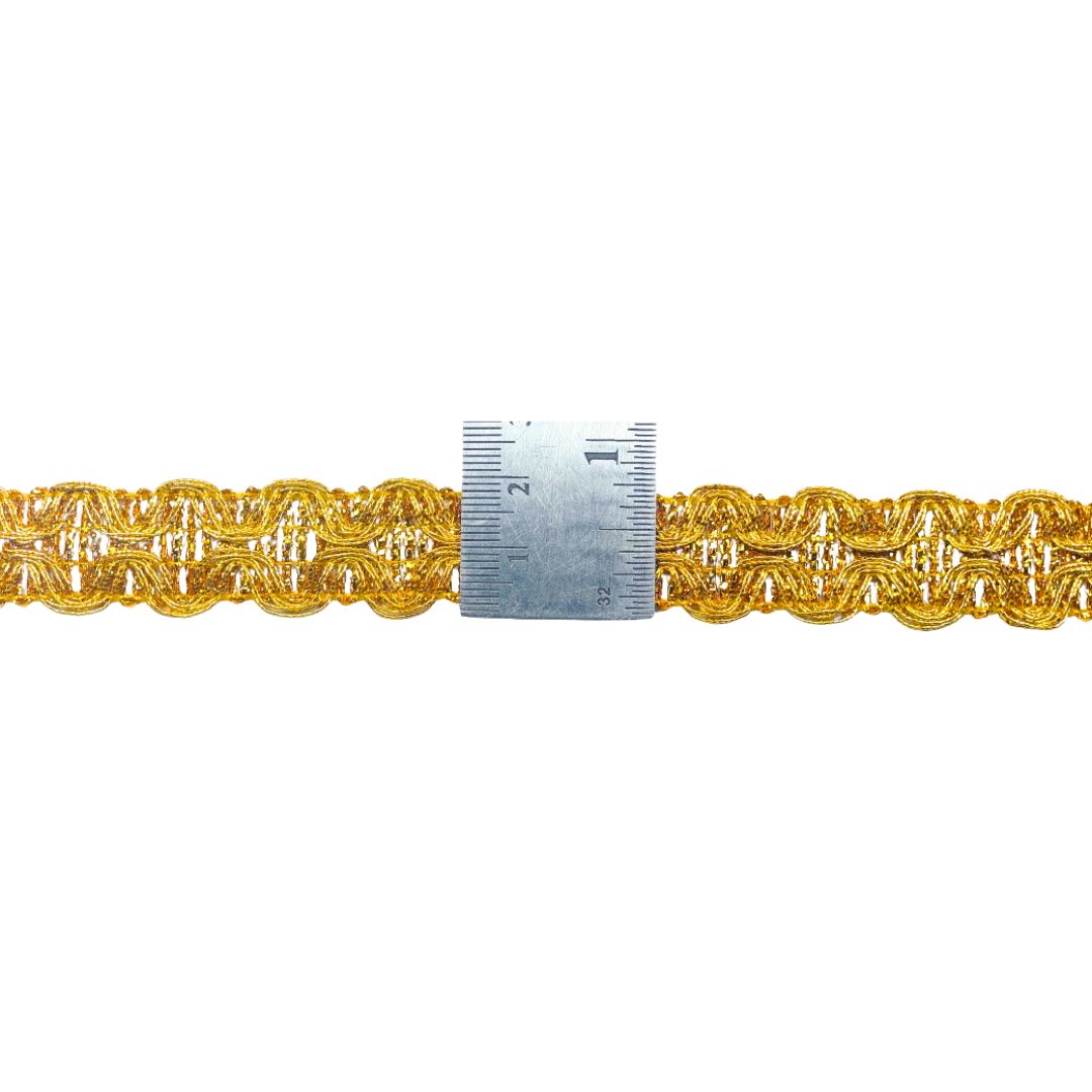 Gold braided cord with a ruler for scale on a white background