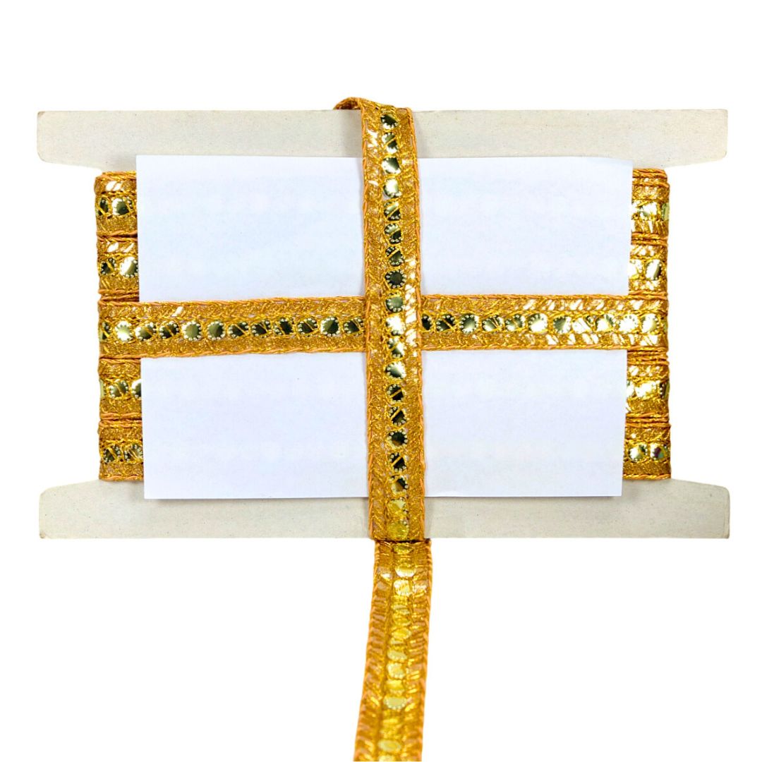 Decorative gold ribbon with a white card on a white background