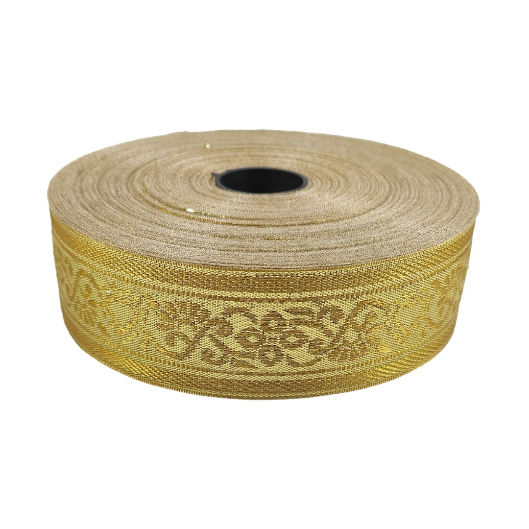 Roll of gold ribbon with decorative pattern on a white background