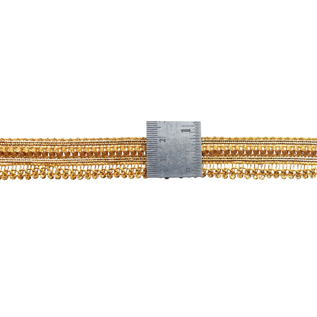 Gold chain with a ruler for scale on a white background