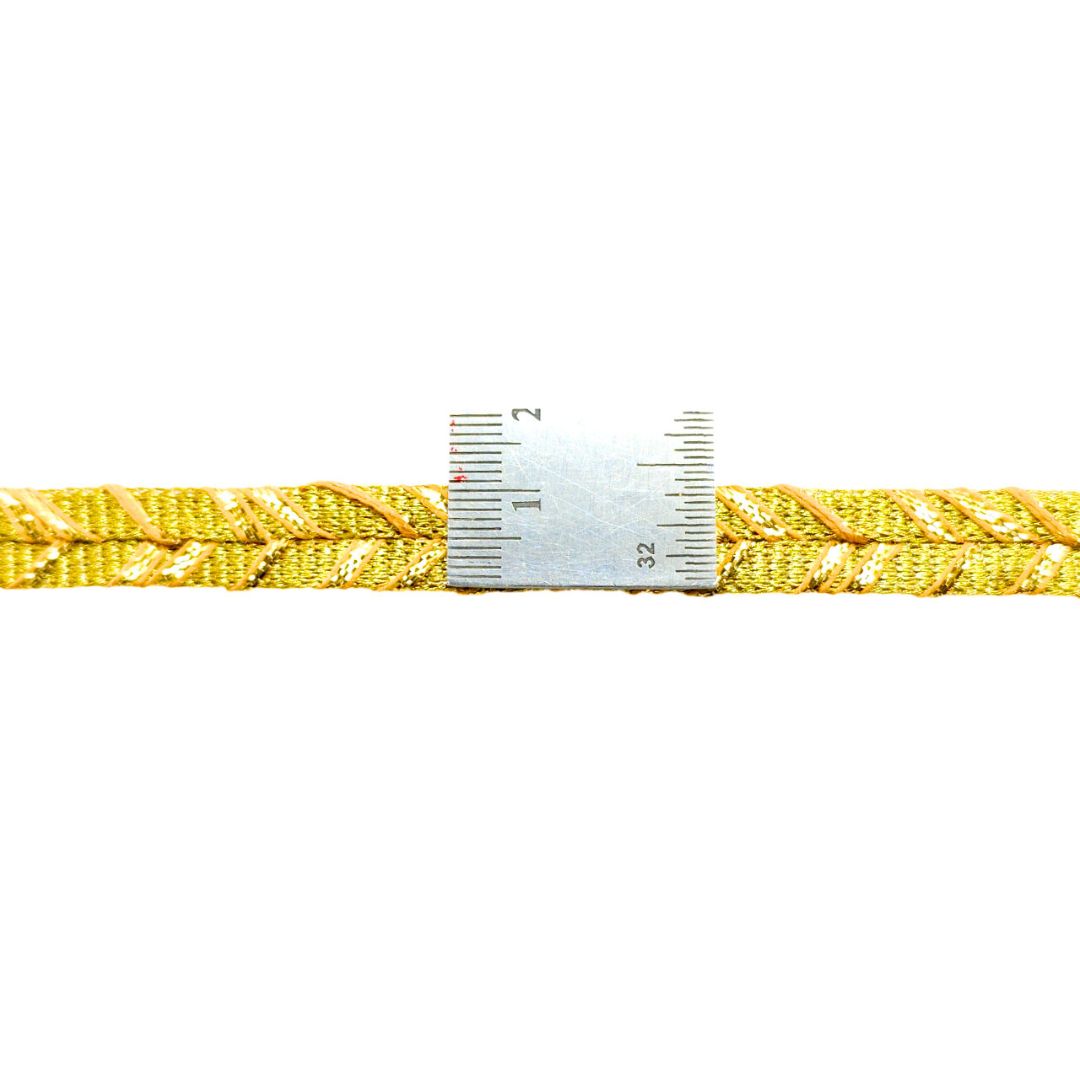 Yellow braided cord with a ruler for scale on a white background