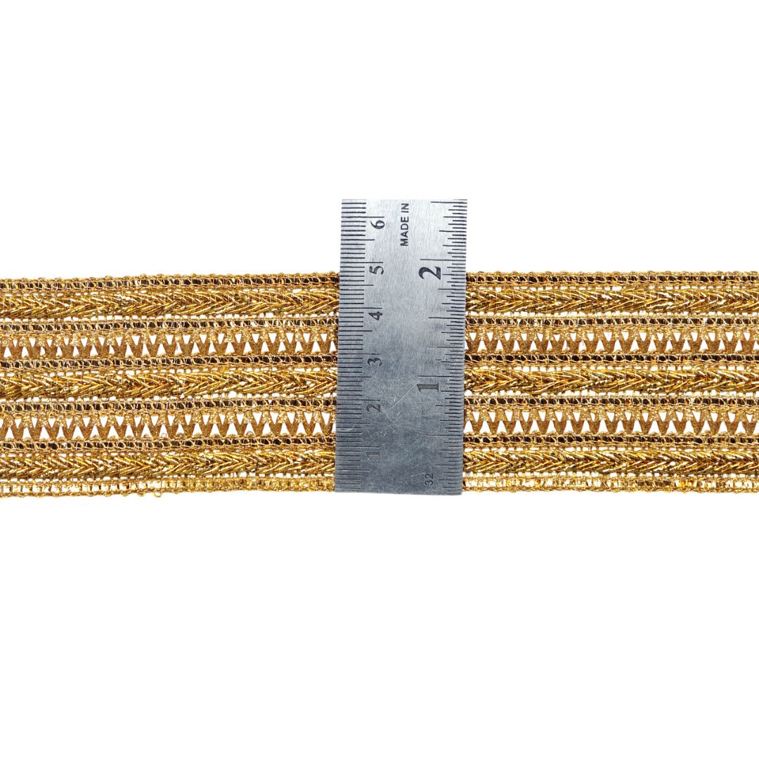 Gold braided cord with a ruler for scale on a white background