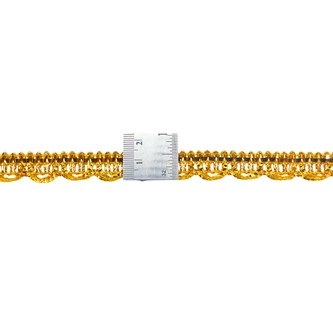 Gold chain with a ruler for scale on a white background