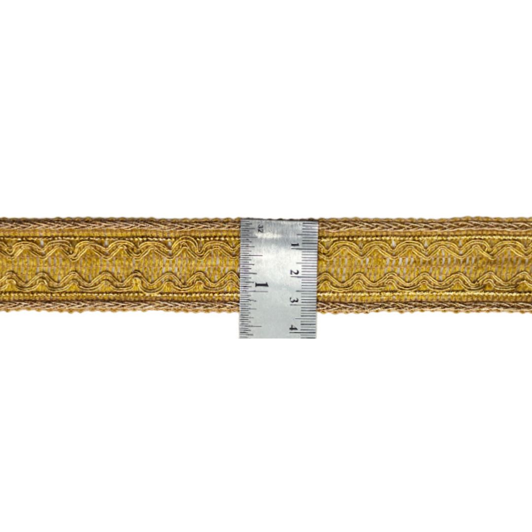 Gold lace trim with a ruler for measurement on a white background