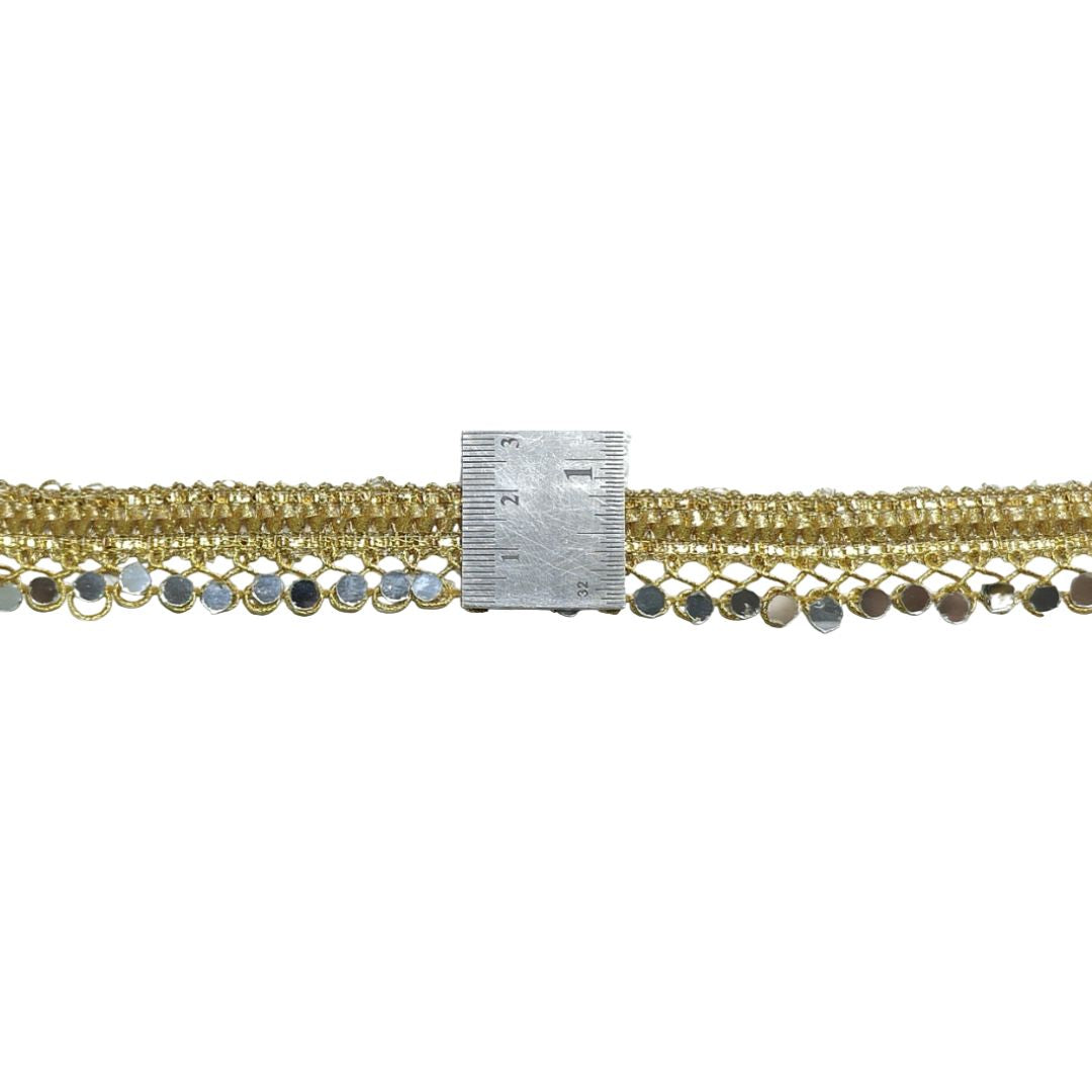 Gold chain with a ruler for scale on a white background