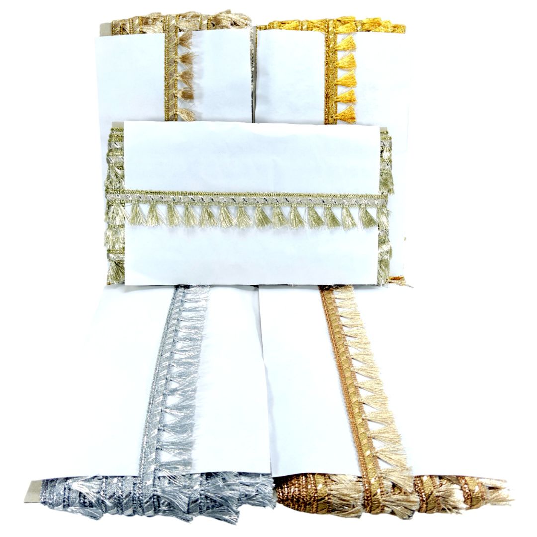 Set of white napkins with gold and silver fringe on a white background