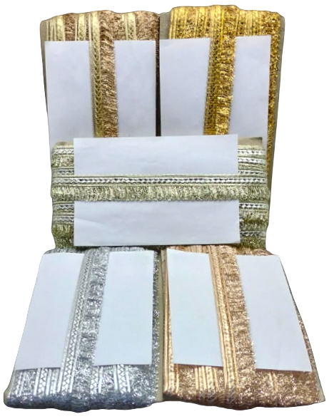 Decorative pillow with gold, silver, and white pattern on a white background