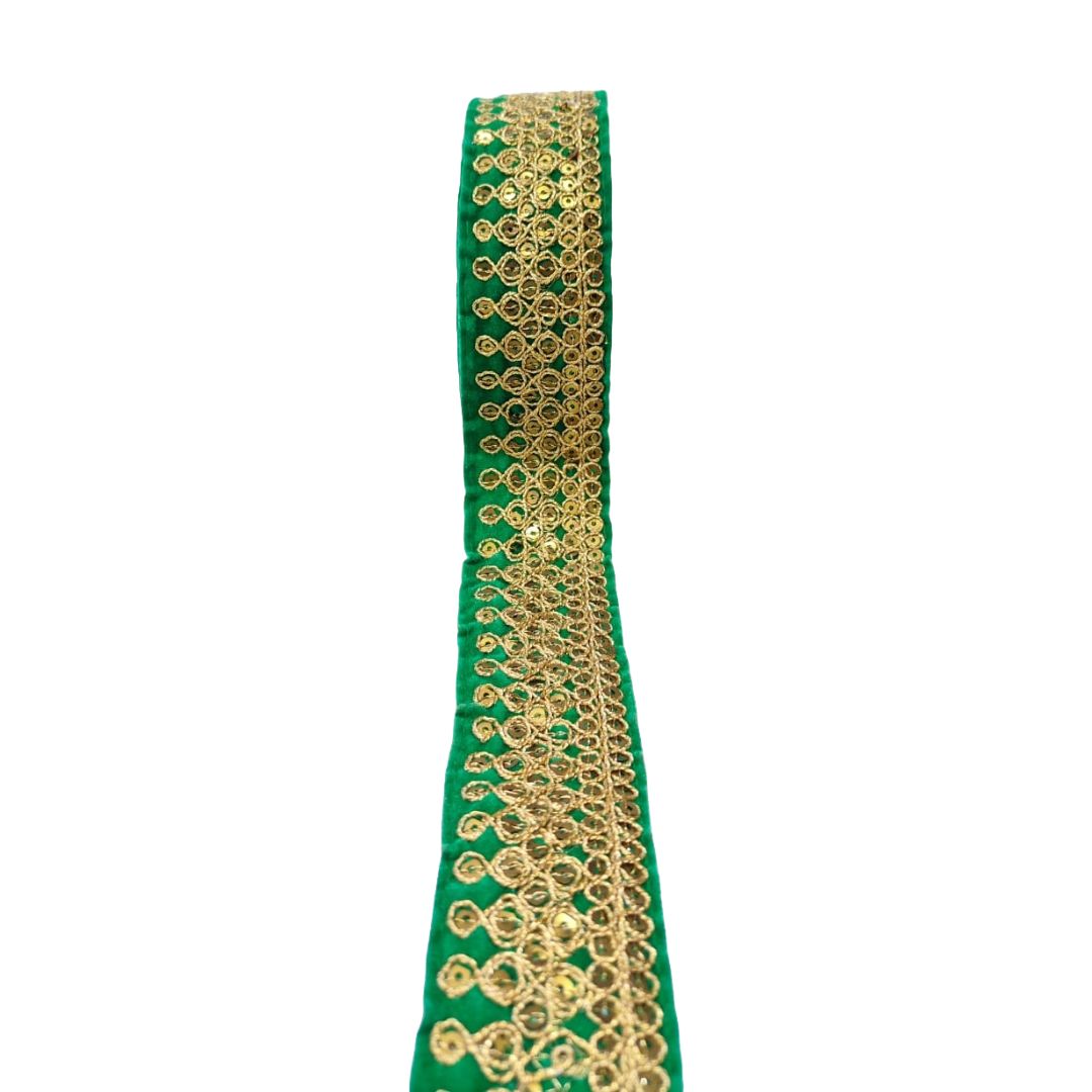 Green ribbon with gold lace border on a white background