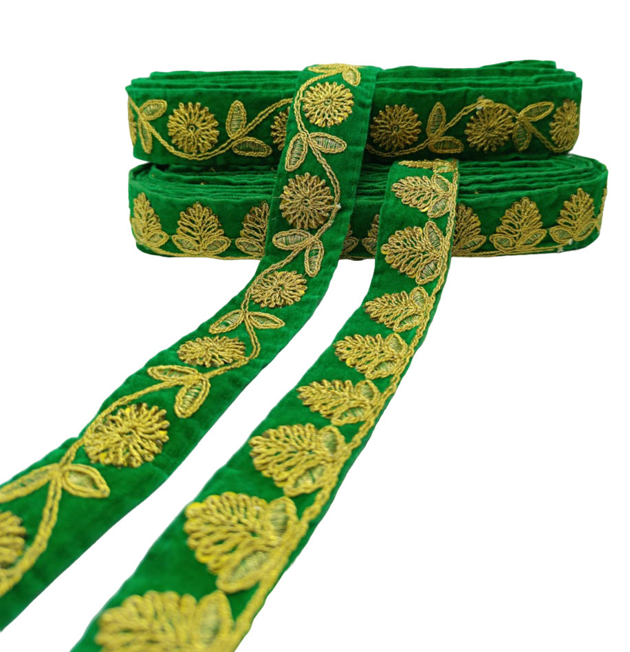 Green ribbon with gold floral embroidery on a white background