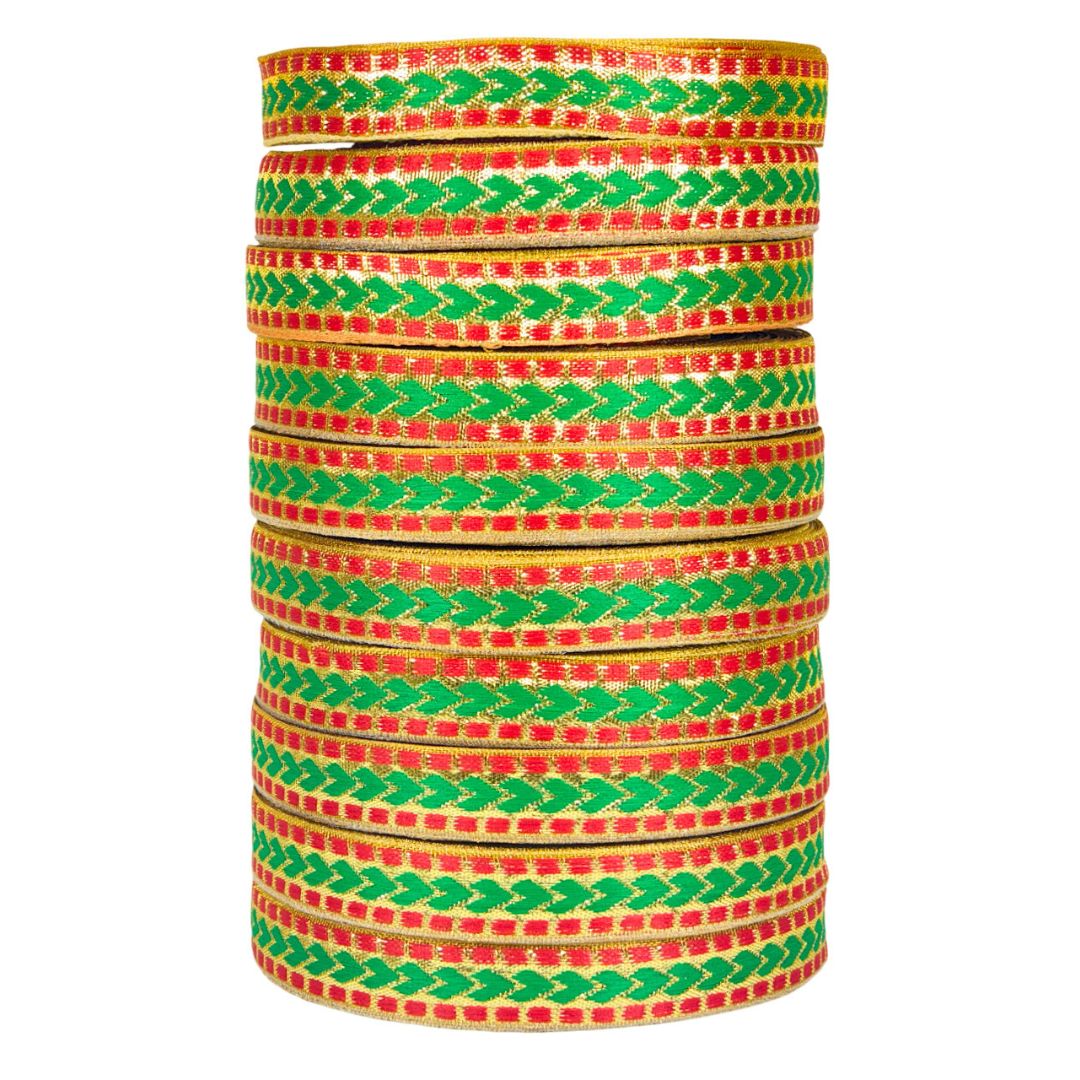 Stack of colorful bangles with green and red patterns on a white background