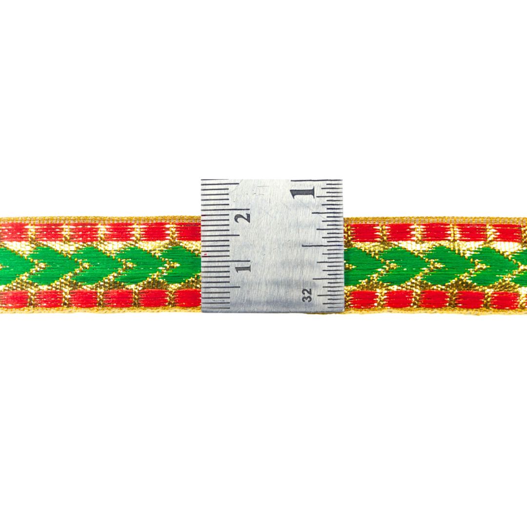 Woven belt with green and red pattern and a ruler for scale on a white background