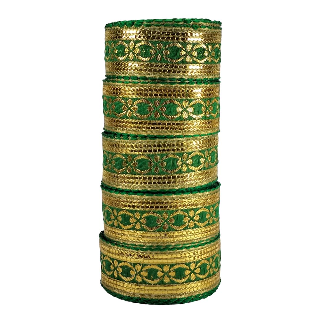 Stack of gold and green bangles on a white background