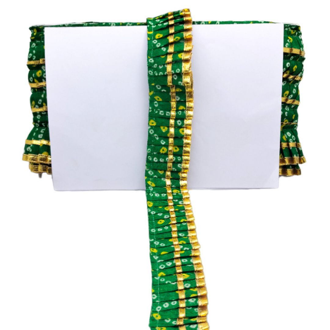 Green and gold fabric with a white background