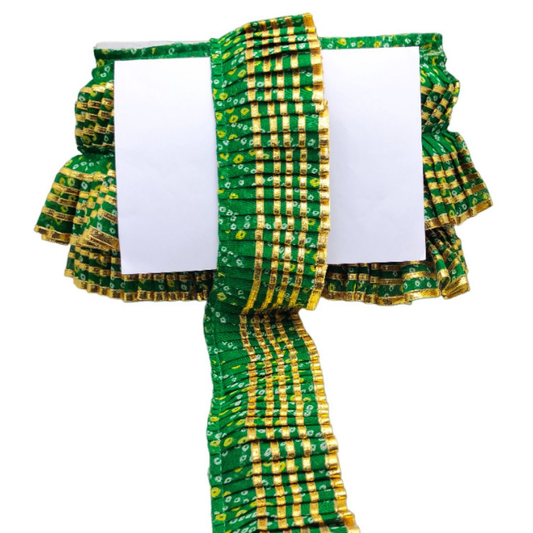 Green and yellow patterned fabric with a white card inside on a white background