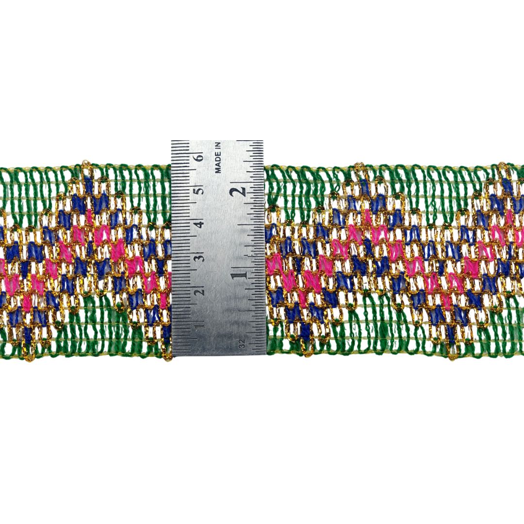Multicolored beaded trim with a ruler for scale on a white background