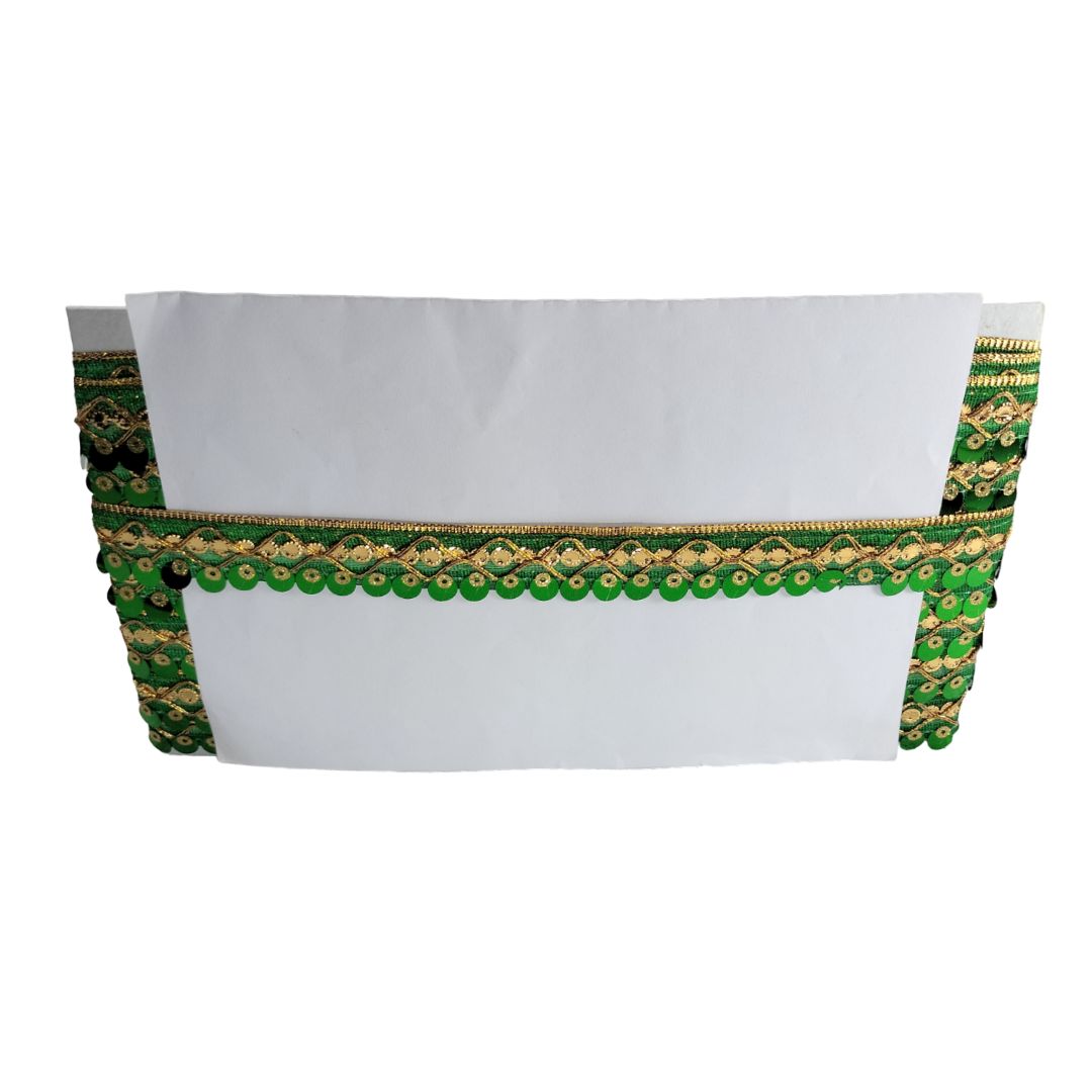 White blouse with green and gold embroidery on a white background