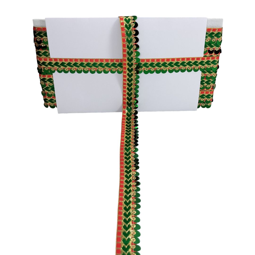White fabric with green and red decorative border on a white background