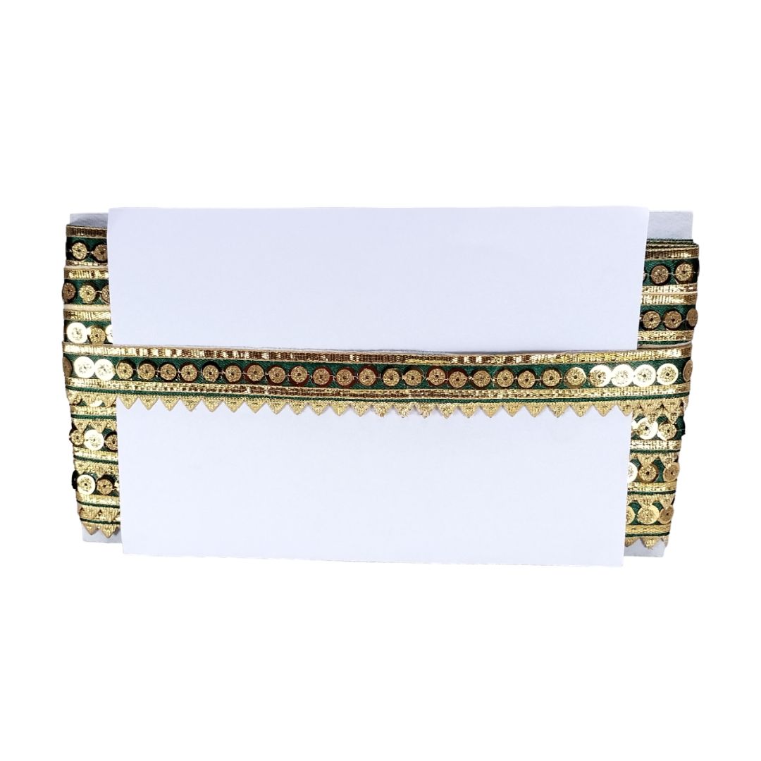 Decorative table runner with gold and green patterns on a white background