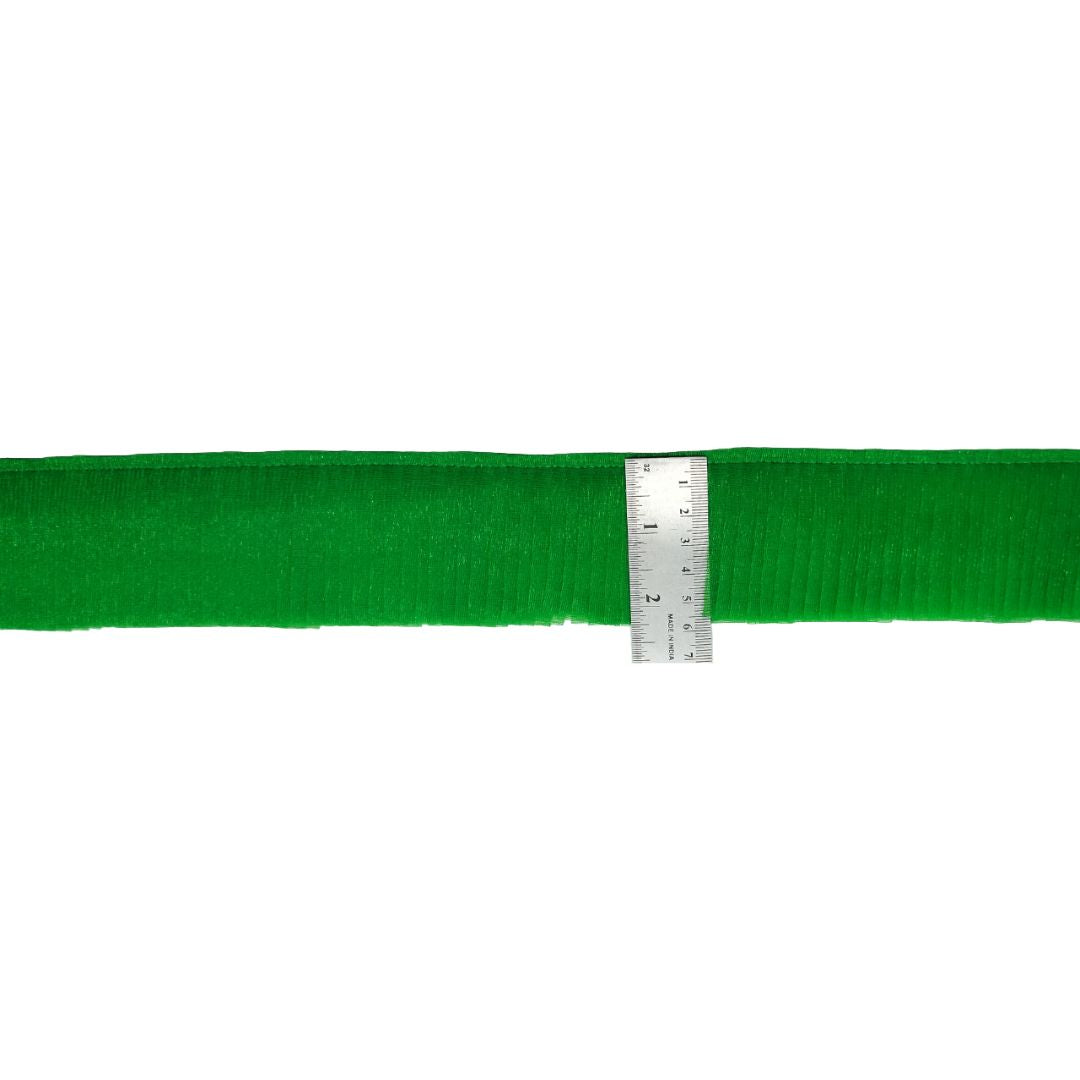 Green belt with a ruler for scale on a white background