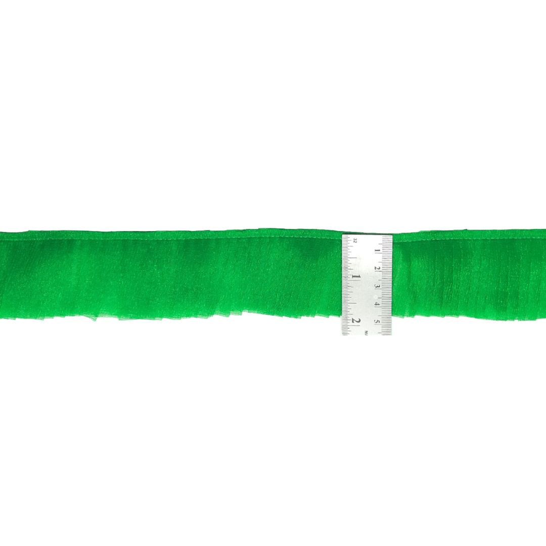 Green yarn with a ruler on a white background