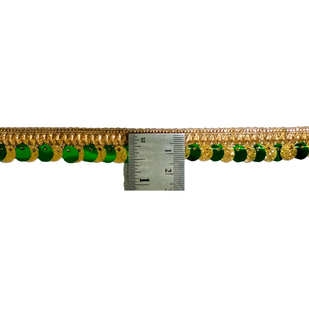 Gold and green beaded trim with a ruler for scale on a white background