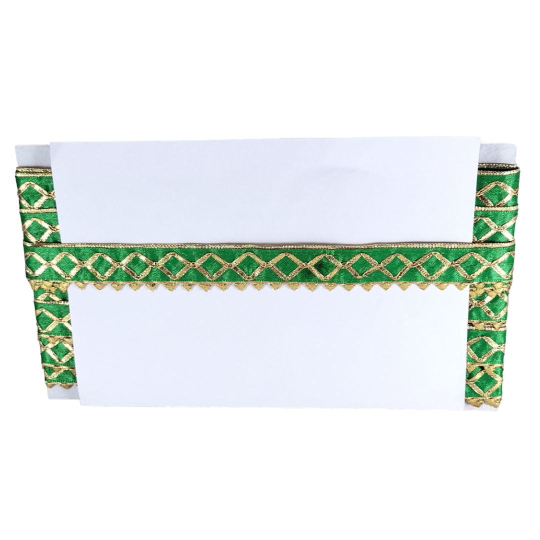 Green and gold decorative item with a white center on a white background