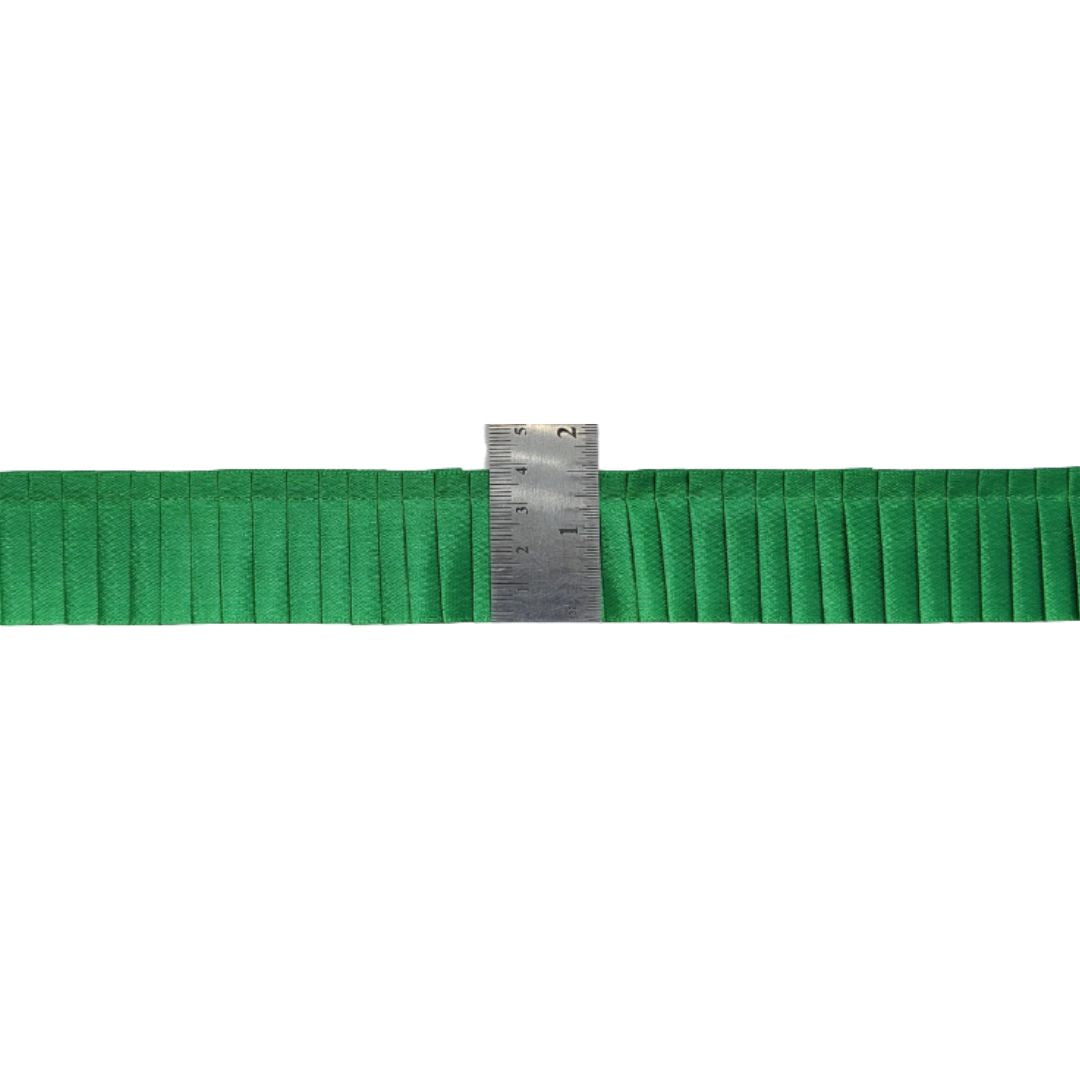 Green ribbon with a ruler for scale on a white background