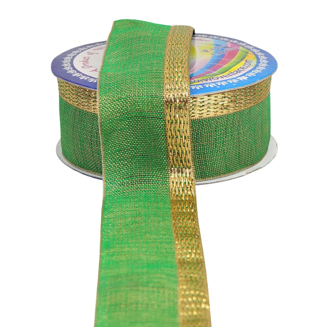 Green and gold ribbon on a spool with a colorful label