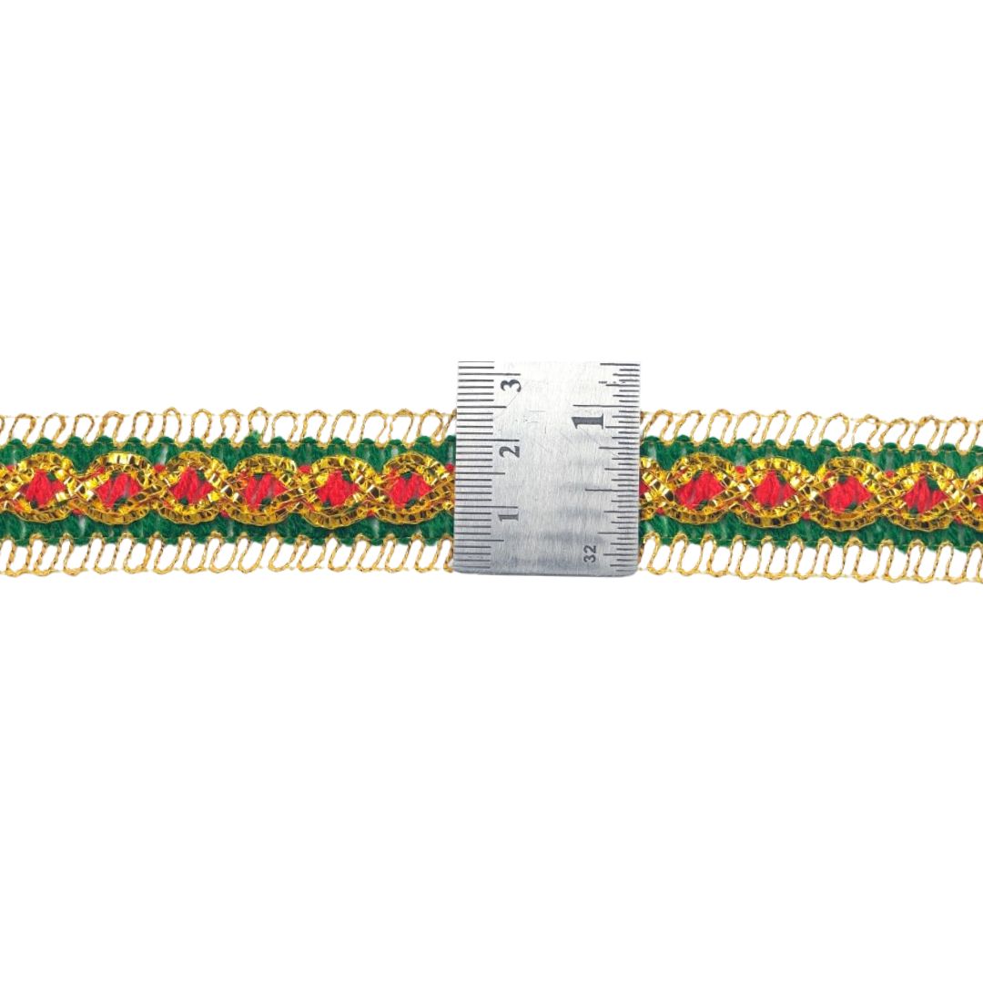 Decorative ribbon with red flowers and green leaves, measured against a ruler on a white background