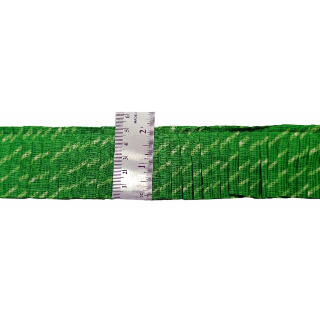 Green webbing with a silver ruler showing measurements on a white background