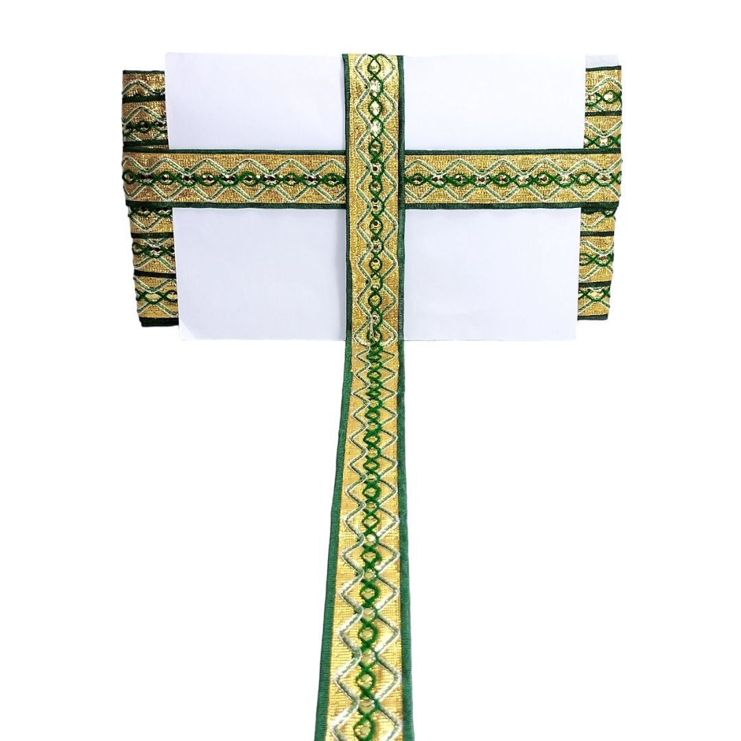 Decorative cross with green and gold patterns on a white background