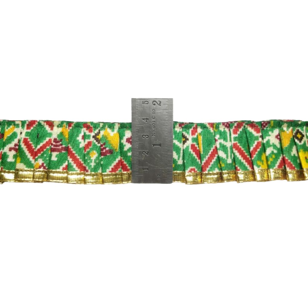 Patterned ribbon with a ruler for scale on a white background