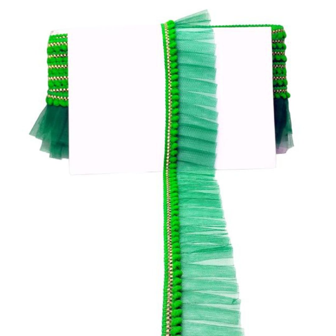 Green tassel trim on a white background