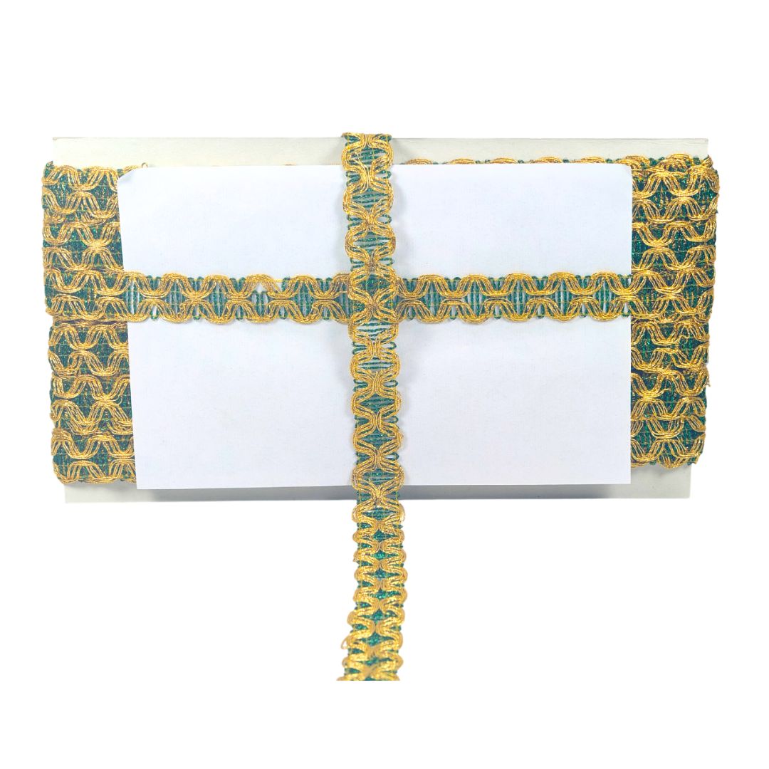 Clutch bag with green and gold pattern on a white background