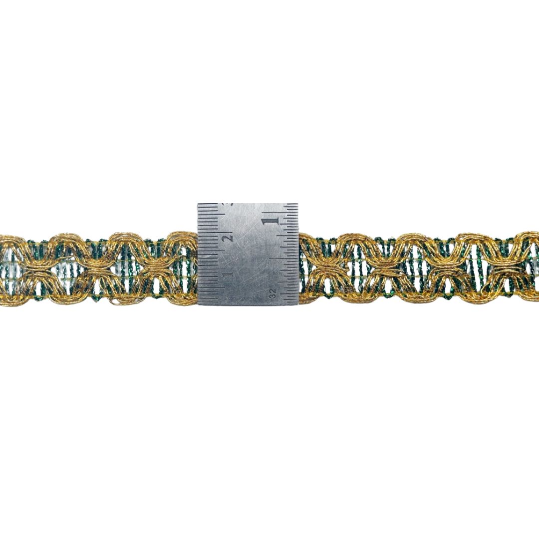 Decorative gold and green braided trim with a ruler for scale on a white background