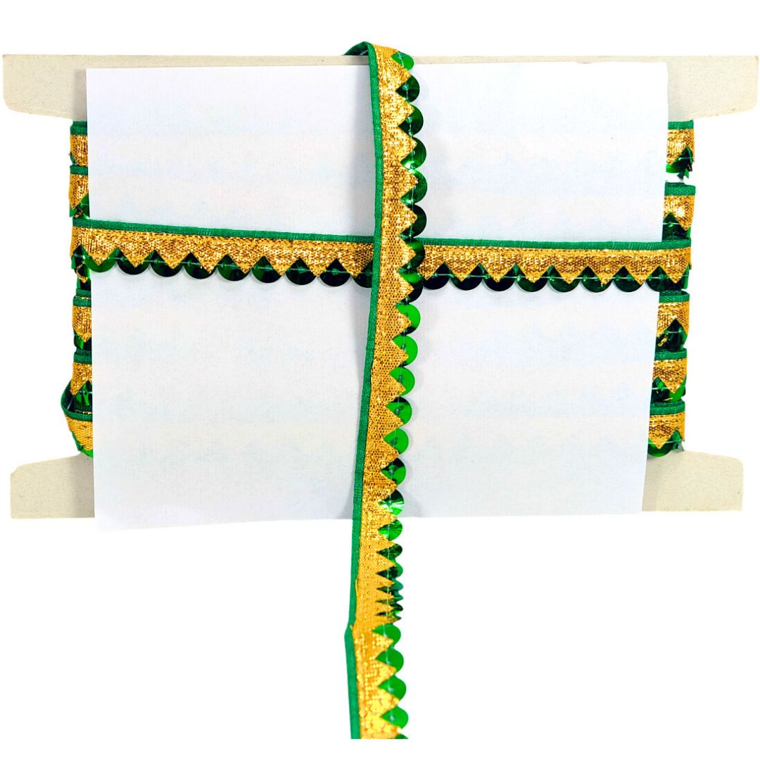 White saree with green and gold border on a wooden hanger