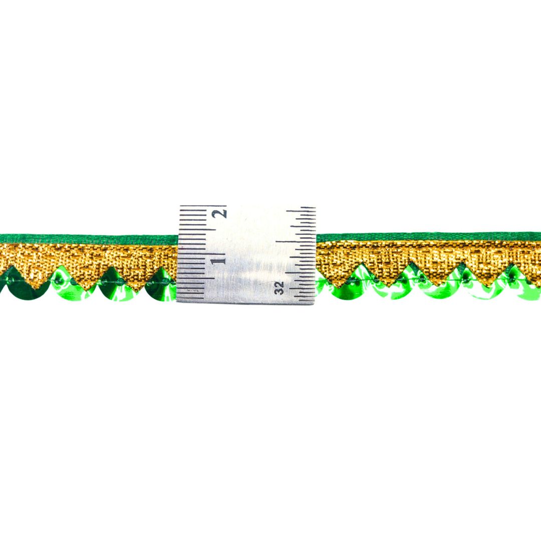 Gold and green decorative trim with a ruler for scale on a white background