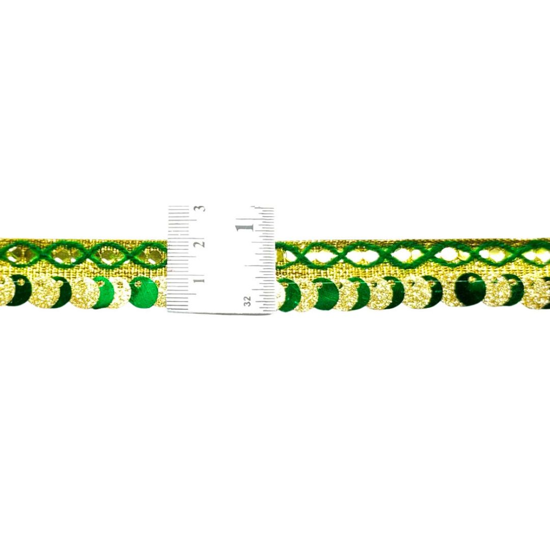 Gold and green decorative trim with a ruler for scale on a white background