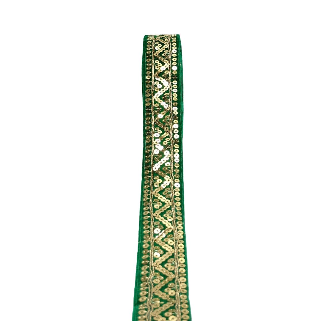 Green ribbon with gold embroidery on a white background
