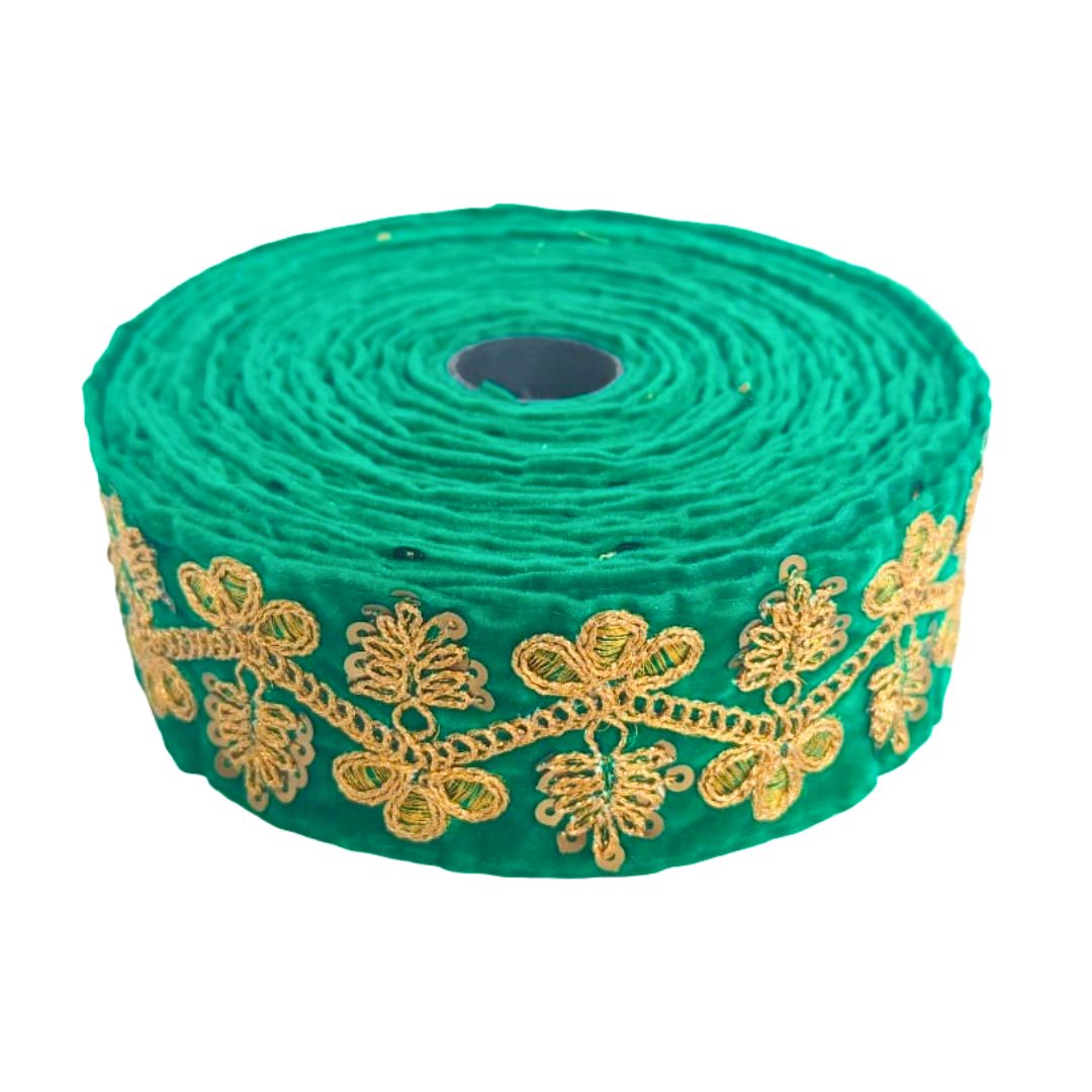 Roll of green lace with gold embroidery on a white background