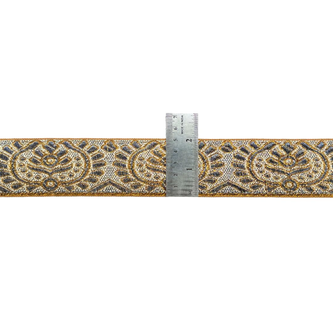 Decorative ribbon with intricate pattern and a ruler for scale on a white background