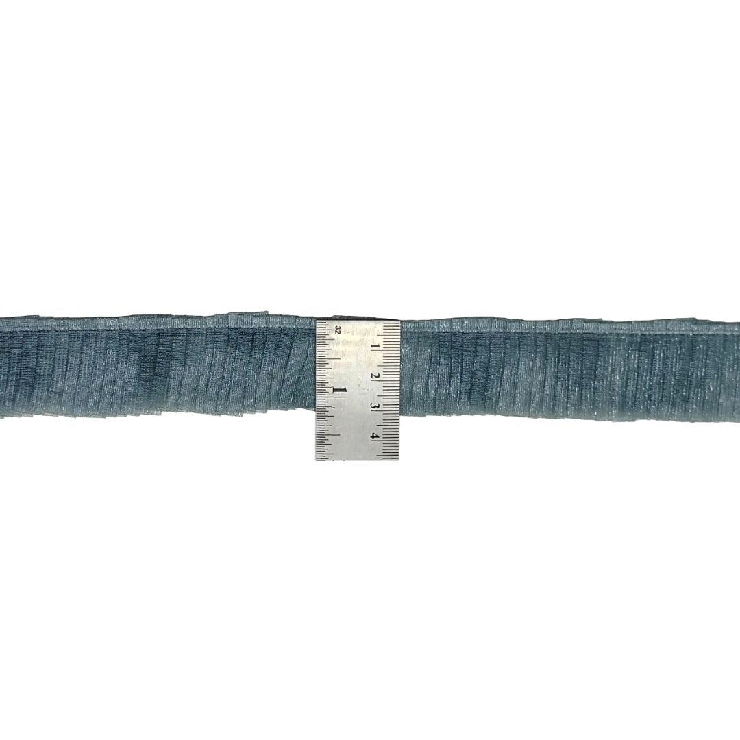 Blue ribbon with a ruler for measurement on a white background